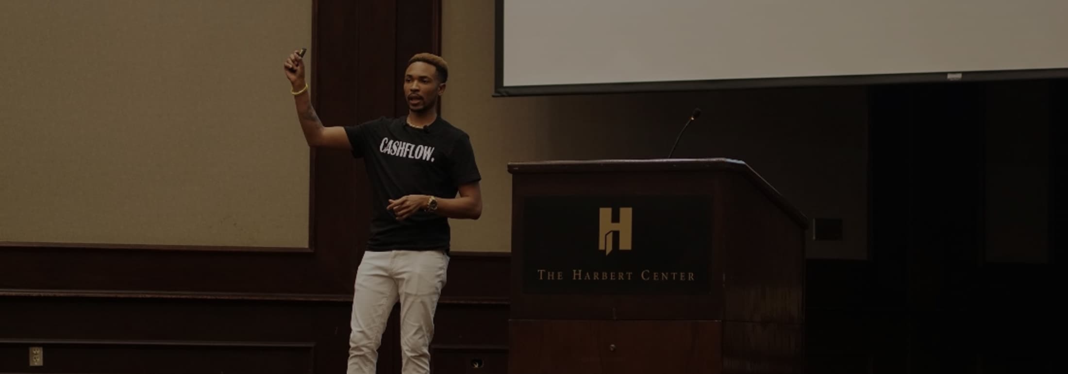 Antonio Edwards presenting on stage at The Harbert Center