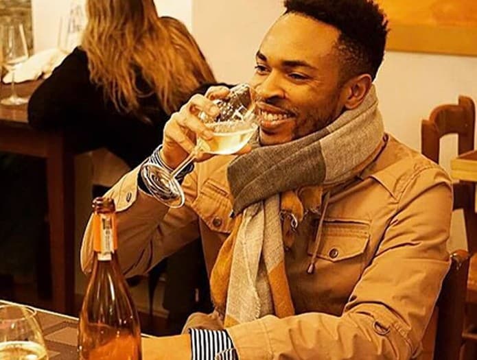 Antonio Edwards raising a glass at dinner