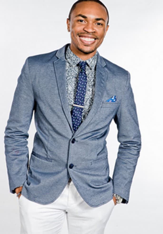 Portrait of Antonio Edwards smiling in a blue blazer and tie