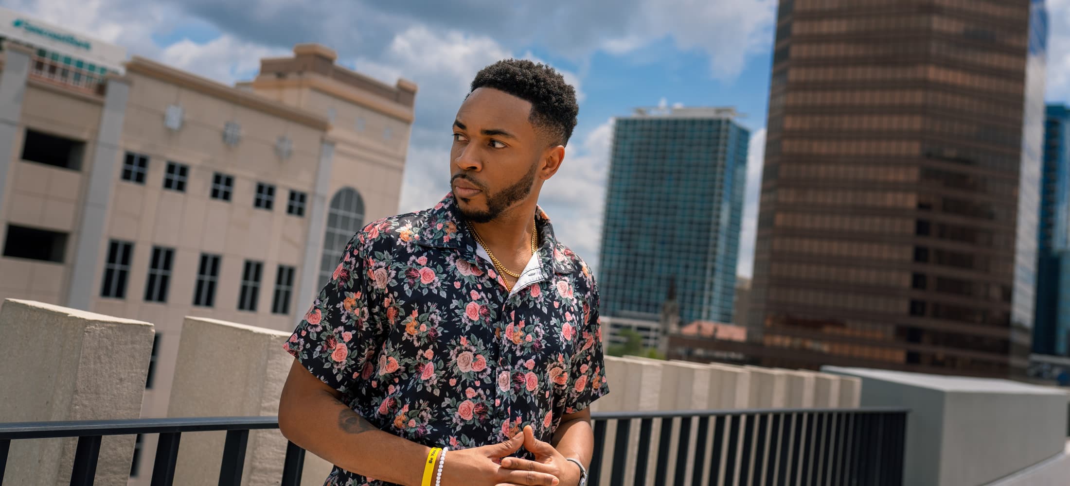 Antonio Edwards on a city rooftop, looking out over the skyline